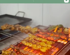 Kebab skewers grilling over open flame
